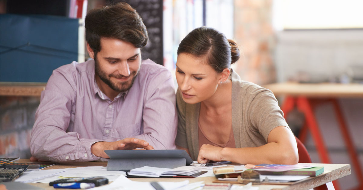 Tablet, design and creative business team in office together for design planning. Technology, collaboration or teamwork with man and woman designer in workplace for meeting, strategy or discussion.